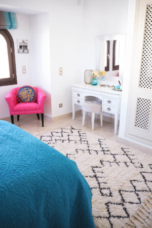 spanish bedroom, interiors, white interiors, pink chair